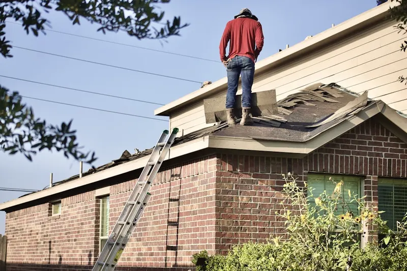 Professional roofer working on a residential roof in Woodland Park